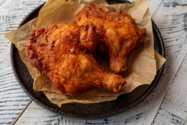istock Crispy chicken thighs fried on a wooden table 1805155315