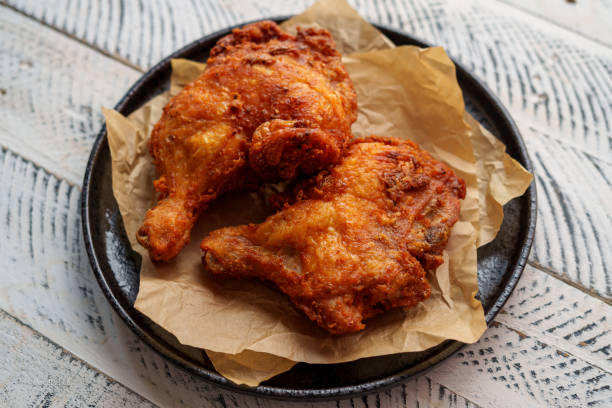 istock Crispy chicken thighs fried on a wooden table 1805155316