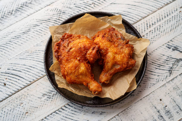 istock Crispy chicken thighs fried on a wooden table 1805155318