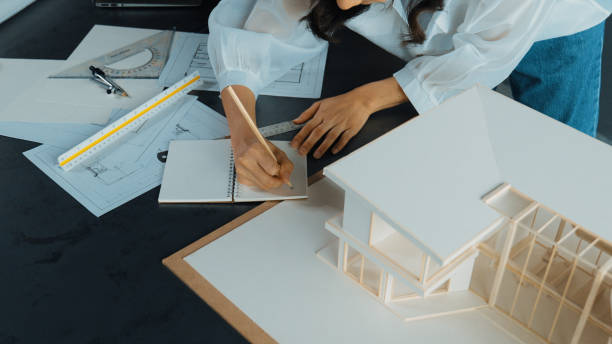 istock Top view of architect hands taking note about house construction. Manipulator. 1805160569