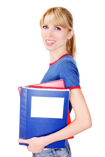 blonde girl is looking at the camera holding a multicolored folders