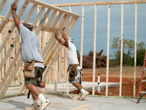 House framers putting up the wall on a house.