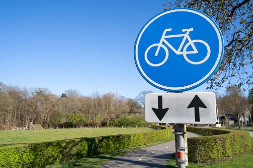 Round blue bicycle sign on a cycle path