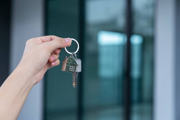 istock Female Hand Holding House Keys 1805183290