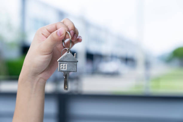 istock Female Hand Holding House Keys 1805183291