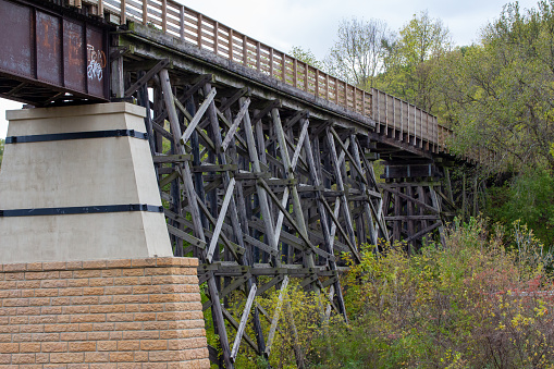 Mankato, Minnesota, USA - October 14, 2023: Landscape view of the Red Jacket Trestle Bridge, an historic railroad trestle bridge built in 1874. After the railroad was abandoned, the bridge became a focal point in the development of a successful bicycle trail system in the greater Mankato area.