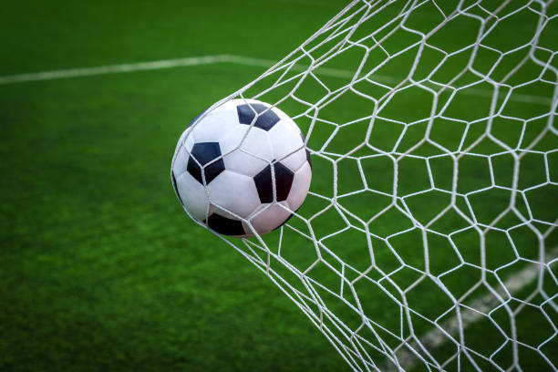 istock soccer ball on goal with net background 1805189278