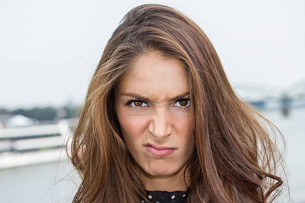 Portrait of angry woman looking at camera.
