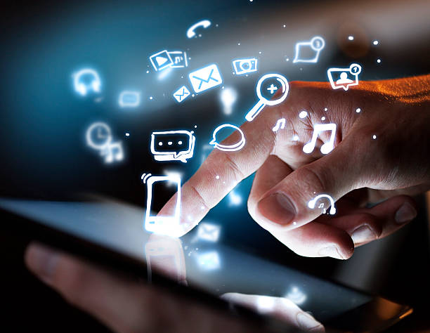 istock Man uses tablet with floating social media icons 180519514