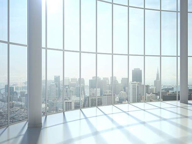 istock Sun shines through large window with view of city 180519959