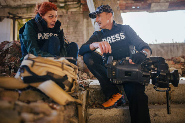 istock war reporters work on a laptop and transmit the live situation 1805199987