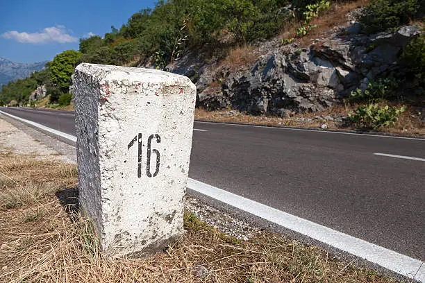 Photo of White kilometer stone post on the roadside in Montenegro