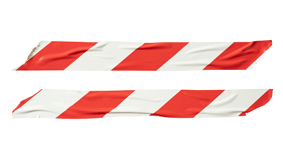 Red and white barricade tape on white background with clipping path