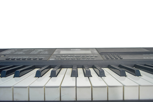 digital piano on a plain white wall background