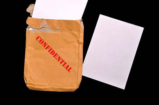 istock Envelope with top secret stamp and blank papers. 180524848