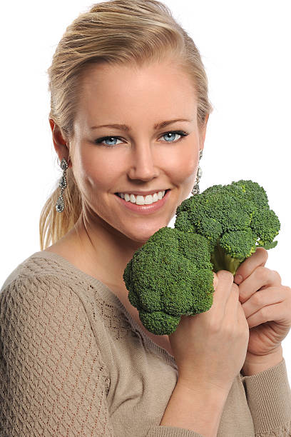 istock Young Woman Holding Broccoli 180524955