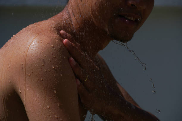 istock asian men take a bath and water splashing. 1805266546