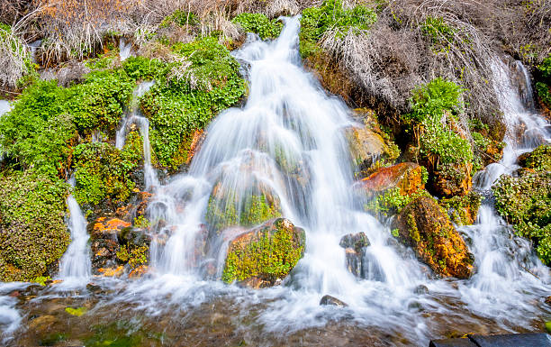 istock Spring pours out of the groups to form a waterfall 180527637