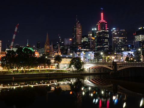 Melbourne city skyline at night next to the Yarra River