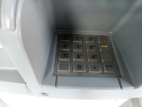 Close up on woman's hand inserting a card in banking machine