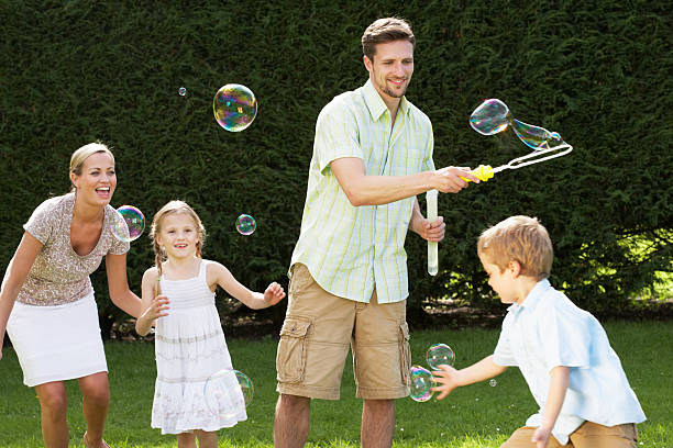 istock Family Playing With Bubbles In Garden 180529163