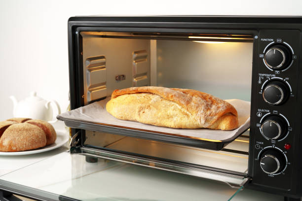 istock Freshly baked bread in mini oven in the kitchen 1805309526