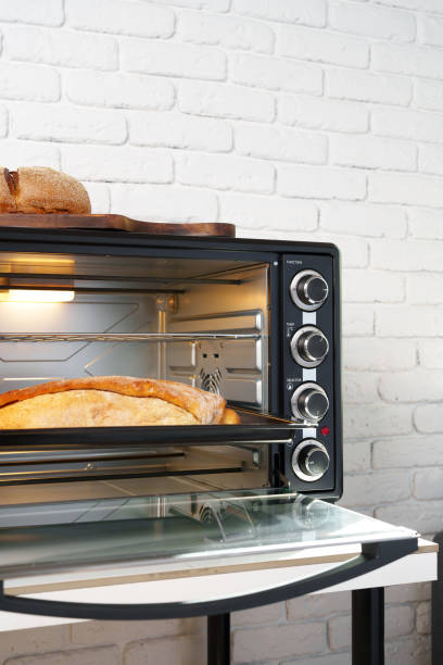 istock Freshly baked bread in mini oven in the kitchen 1805313933