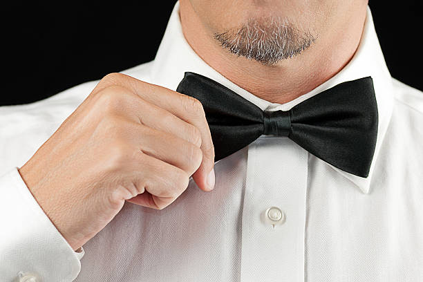 istock Man In Tux Straightens Bowtie, One Hand 180532216