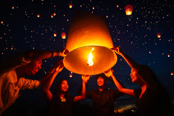 istock Asian couple traveller setting yi peng  lantern in loi krathong festivities 1805325030