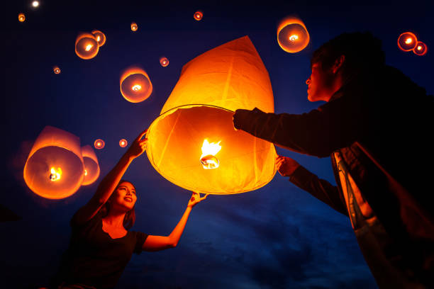 istock Asian couple traveller setting yi peng  lantern in loi krathong festivities 1805325047