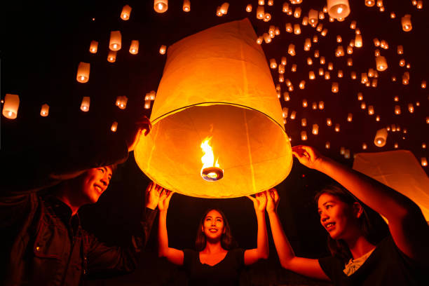 istock Asian couple traveller setting yi peng  lantern in loi krathong festivities 1805325053