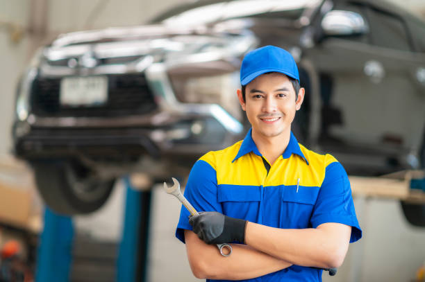istock repairman and technician in car garage service in blue uniform 1805327163