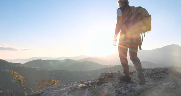 istock Mature male hiker ascends rock ridge 1805346032