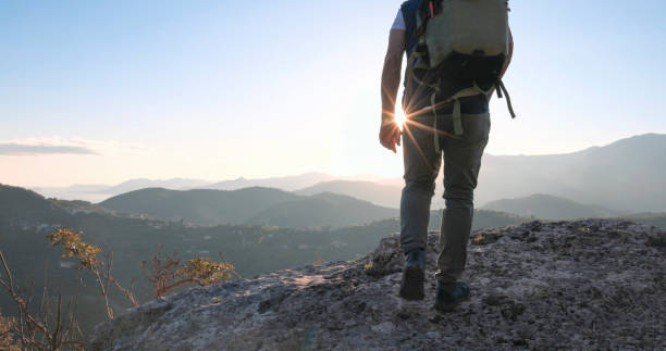 istock Mature male hiker ascends rock ridge 1805346035