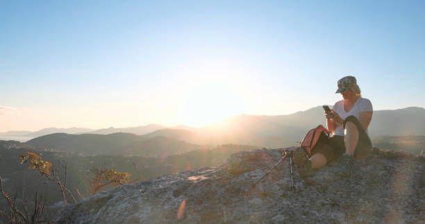 istock Mature female hiker relaxes on rock ridge 1805346572