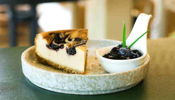Delicious dessert, blueberry pie slices, decorated with fresh berries.
