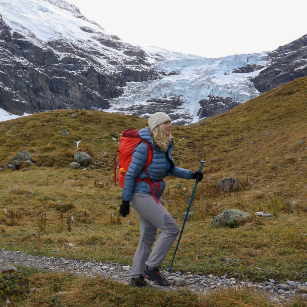 istock Mature woman hikes along path, autumn 1805348179