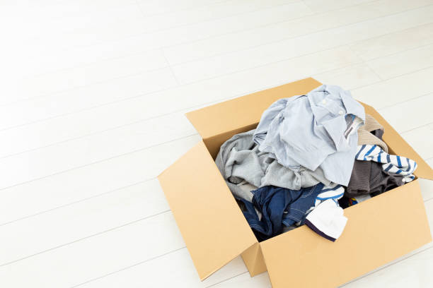 istock Clothing packed in a cardboard box. 1805354680