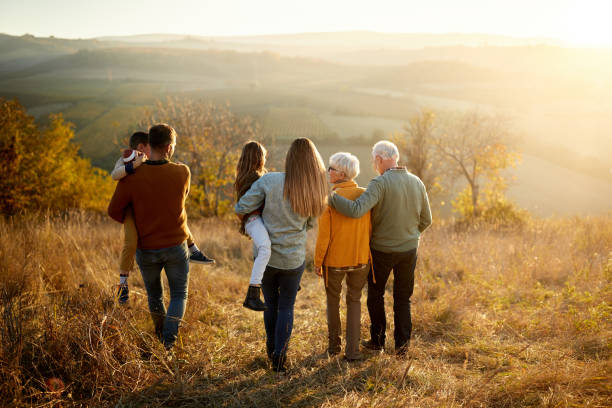 istock Back view of multi-generation family taking a walk on a hill. 1805371386