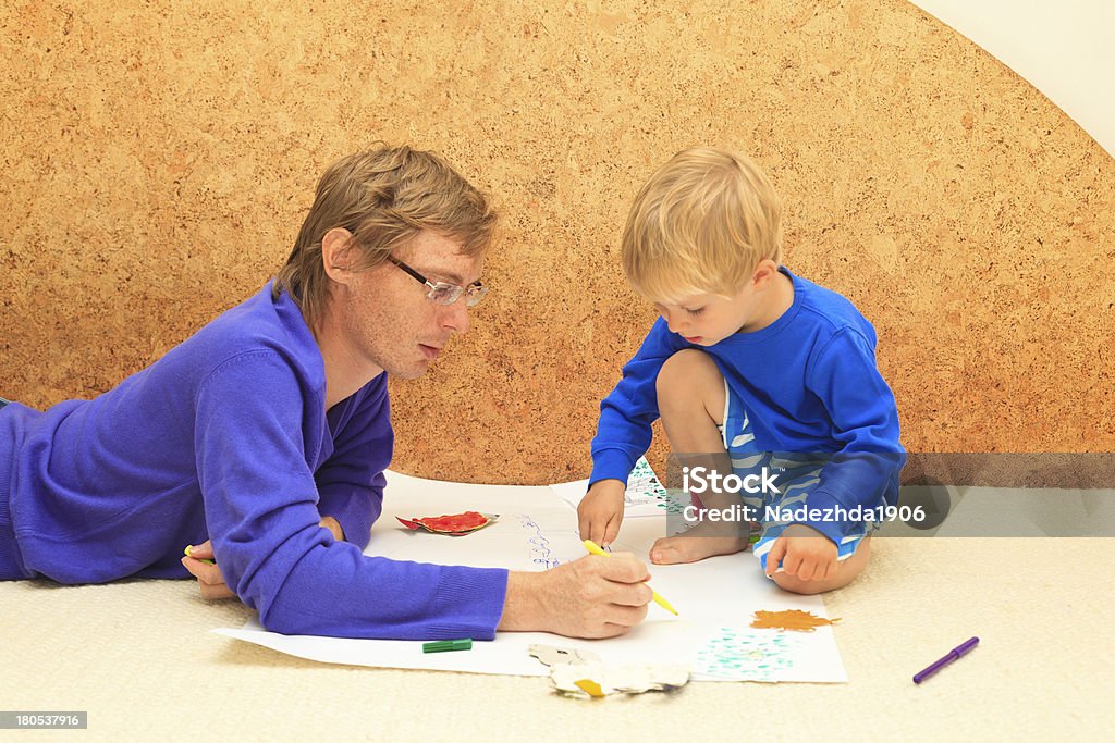 father and son drawing together Activity Stock Photo