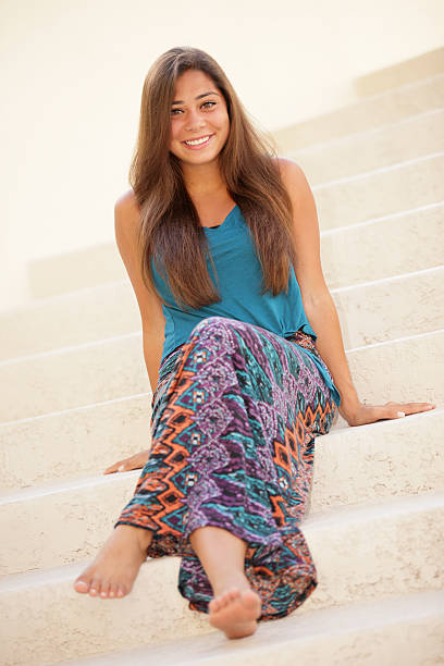 istock Happy woman sitting on a staircase 180538035