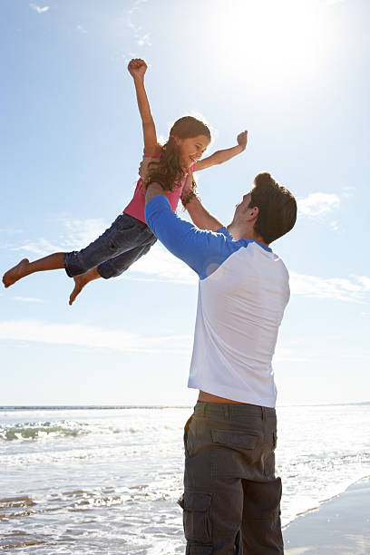 istock Father Throwing Daughter Into Air 180538286
