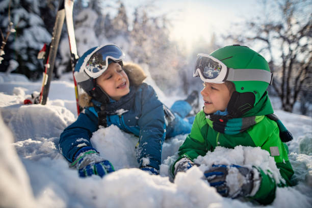 istock Happy kids skiing in beautiful winter forest 1805385985