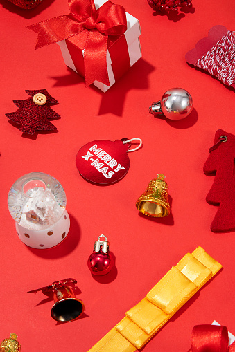 Christmas related objects and ornaments on red background