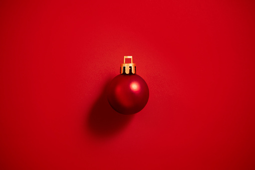 Single Christmas ornament on red background