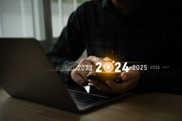 istock Trends 2024 year concept. Man using mobile laptop and showing virtual sequence count down years 2024 wording for marketing monitor and business planning in new year. Technology new year concept. 1805402394
