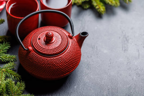 istock Teapot, cup, and fir tree branches create a cozy scene 1805409322