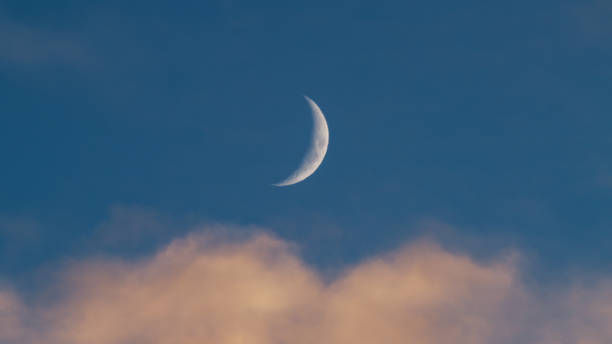 istock Orange Clouds with blue sky and moon in Christmas sky 1805418935
