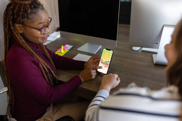 istock Close up of a black office worker using mobile app for food ordering 1805423452
