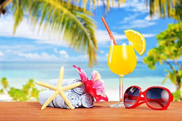 istock Orange cocktail and other summer accessories on a table 180542368